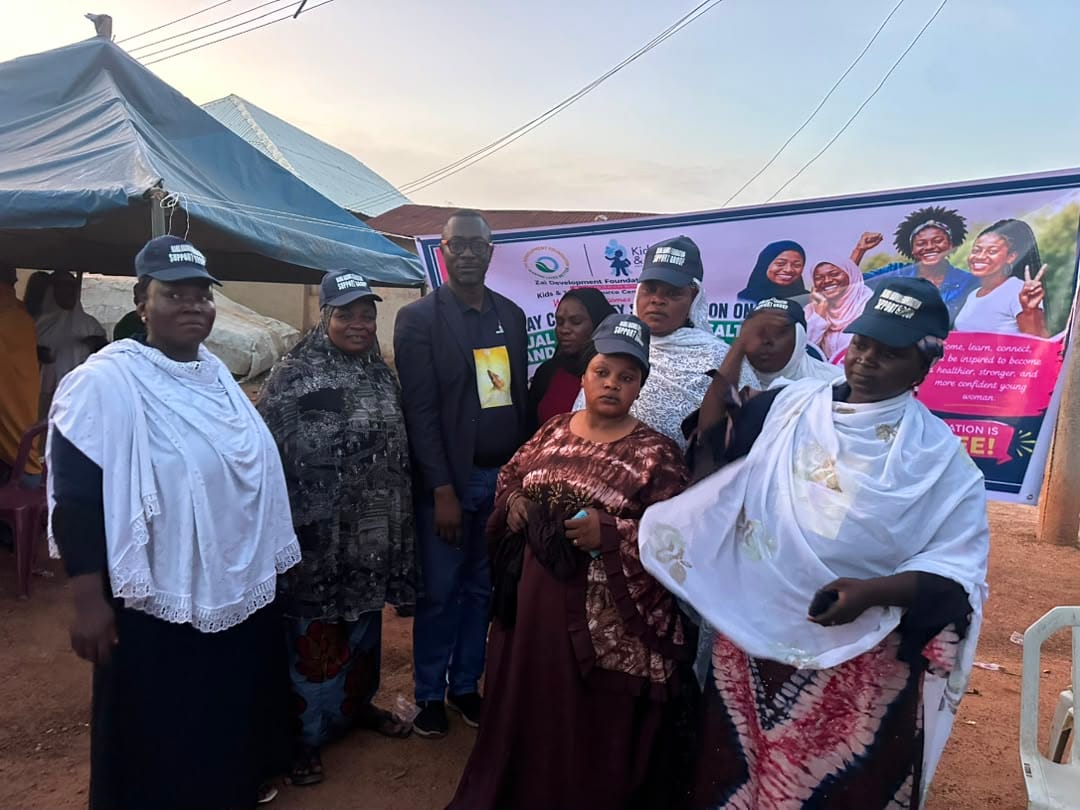 Community members in traditional dress attend the session