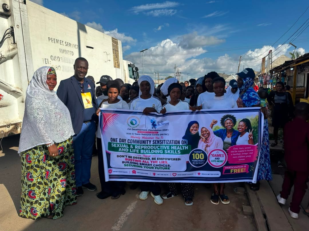 Community members and participants pose with the session banner